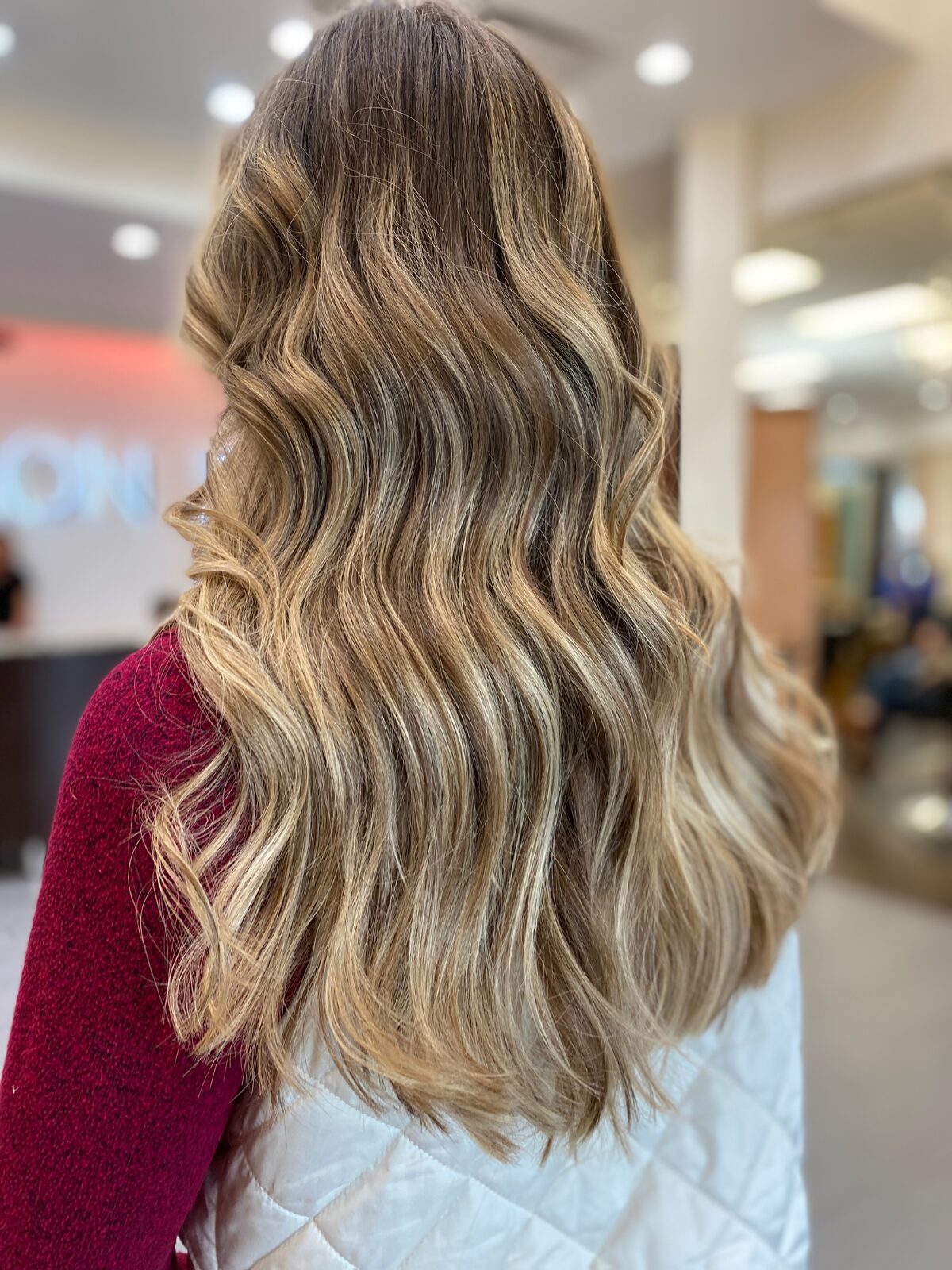 Dimensional lived-in blonde balayage with soft waves, Austin